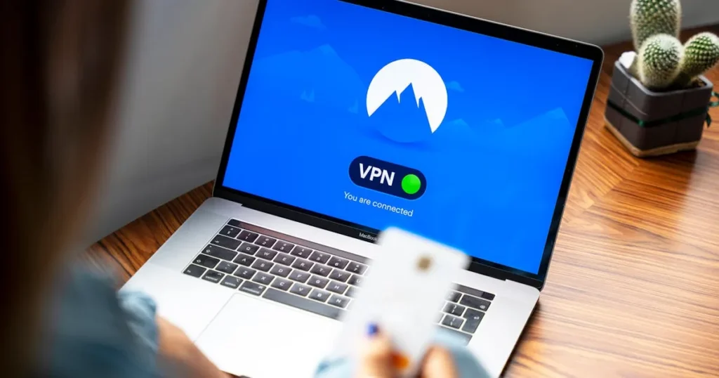 A person using a VPN on a laptop, symbolizing secure internet browsing in a modern indoor setting.