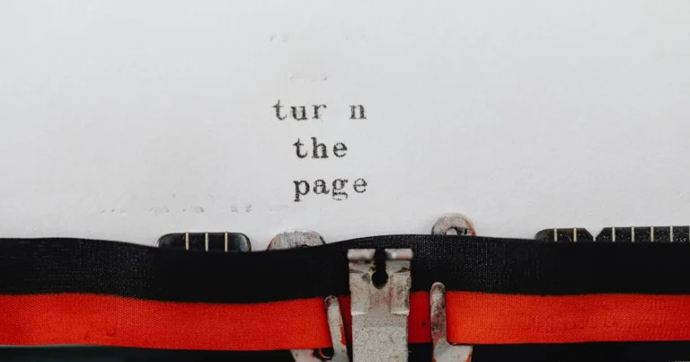 Close-up of a vintage typewriter with text 'turn the page' typed on paper, symbolizing change and ne