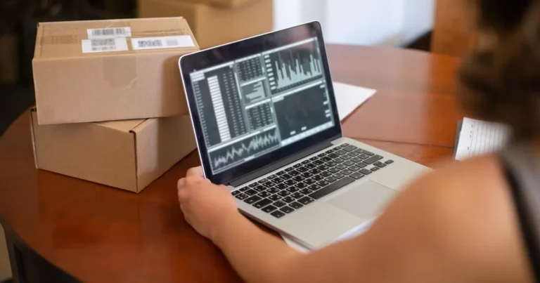 Small business owner managing online orders from a laptop in Portugal.