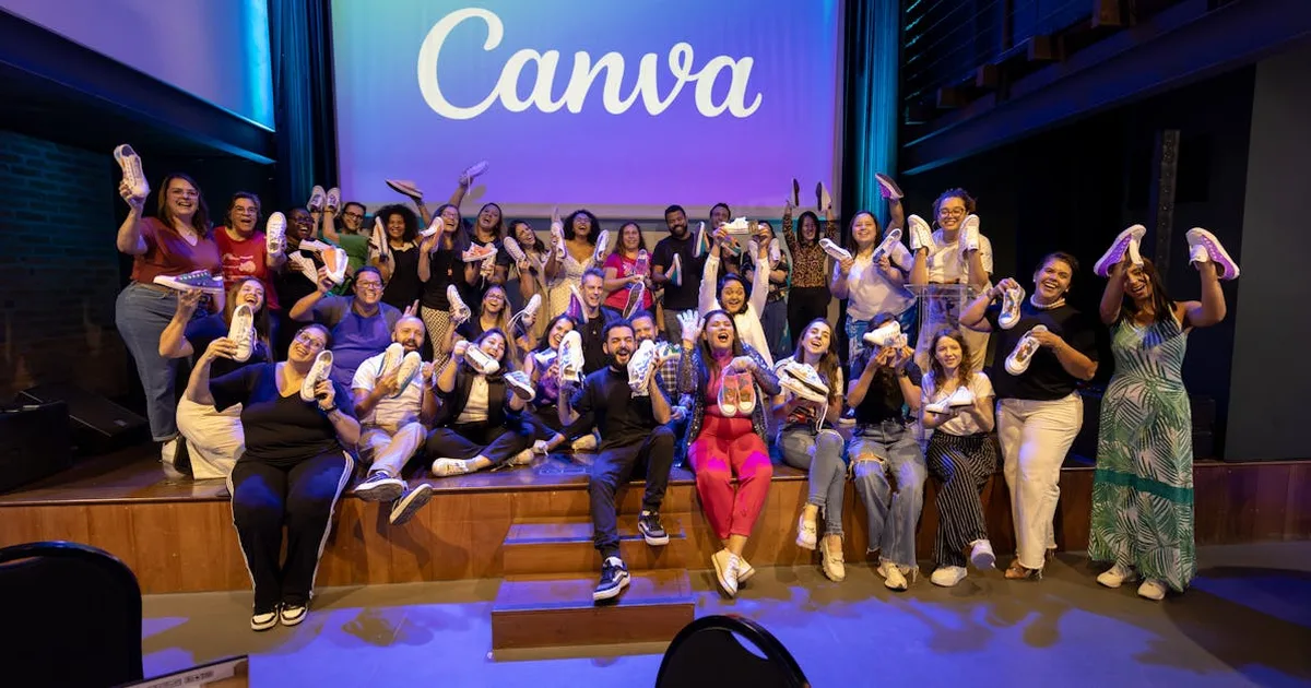 Large group celebrating with personalized shoes at a Canva event indoors