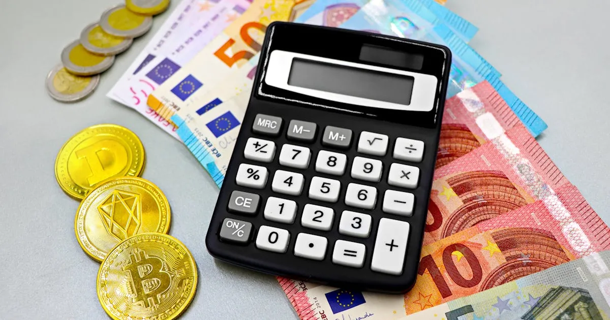 Calculator with euro banknotes and cryptocurrency coins like Bitcoin on a table.
