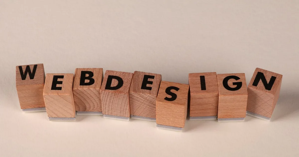 Wooden blocks spelling 'web design' creatively showcase digital design concept.